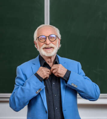 happy senior lecturer buttoning shirt